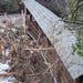 One of the Lutsen Resort’s covered bridges Saturday, damaged by fallen trees in the Poplar River.