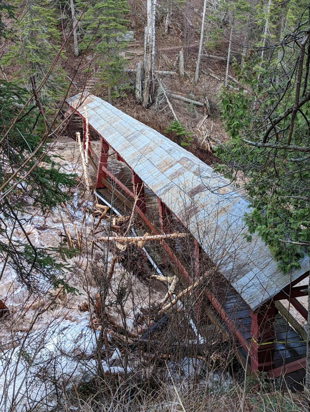 One of the Lutsen Resort's covered bridges Friday, damaged by fallen trees in the Poplar River.