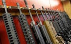 FILE - In this July 20, 2012, photo, a row of different AR-15 style rifles are displayed for sale at the Firing-Line indoor range and gun shop in Auro