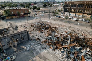 Buildings that were burned during the unrest after the killing of George Floyd remain a pile of rubble at the intersection of 27th Avenue and Lake Str
