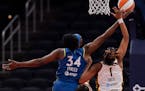 Minnesota Lynx center Sylvia Fowles (34) reaches for a lay-up against Indiana Fever guard NaLyssa Smith (1) during a game earlier this month.