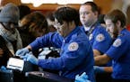 TSA agents checked passengers preparing to board a flight.