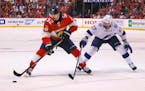 Florida Panthers defenseman MacKenzie Weegar keeps the puck away from Tampa Bay Lightning left wing Alex Killorn during the second period of Game 1 