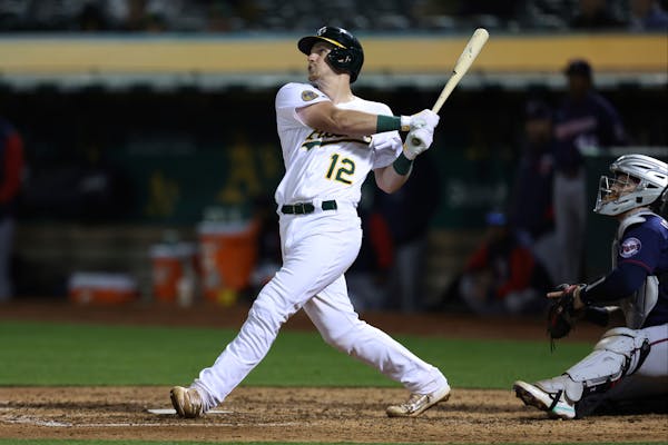 Oakland’s Sean Murphy watches his two-run single in front of Twins catcher Ryan Jeffers during the seventh inning 