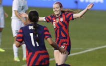Rose Lavelle, right, of the United States, celebrates a first half goal against Uzbekistan, in a women’s soccer match in Chester, Pa., Tuesday, Apri