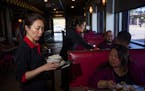 Co-owner Mary Lau served the lunchtime crowd at her restaurant, the Peking Garden in St. Paul, which had to relocate after the riots in May 2020. She 