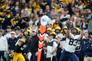 Michigan’s Erick All (83) beat Iowa’s Riley Moss for a TD catch during the 2021 Big Ten Championship Game. Under new NCAA rules, FBS leagues don�