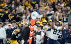 Michigan’s Erick All (83) beat Iowa’s Riley Moss for a TD catch during the 2021 Big Ten Championship Game. Under new NCAA rules, FBS leagues don�