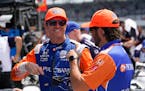Scott Dixon, left, talks with a crew member during practice for the Indianapolis 500 
