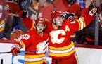 Calgary forward Matthew Tkachuk, right, celebrates his goal against the Oilers with forward Johnny Gaudreau during the third period of Game 1 