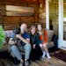 Andy and Sonja Roy with daughter Sadie and dog Oban in their three-season porch in Edina.