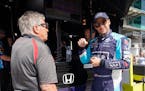 Marco Andretti talks with Mario Andretti during practice for the Indianapolis 500 