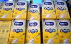 Infant formula is stacked on a table during a baby formula drive to help with the shortage May 14, 2022, in Houston. President Joe Biden has invoked t