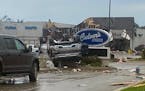 This image provided by Steven Bischer, shows an upended vehicle following an apparent tornado, Friday, May 20, 2022, in Gaylord, Mich.