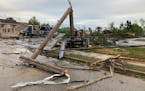 A telephone pole and power lines are seen downed after a tornado came through the area in Gaylord, Mich., Friday, May 20, 2022.