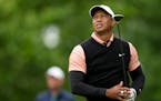 Tiger Woods watches his tee shot on the 17th hole during the third round of the PGA Championship