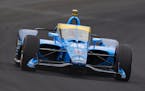 Jimmie Johnson drives through the first turn during qualifications for the Indianapolis 500 on Saturday