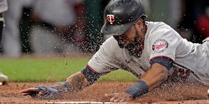 Luis Arraez scored three runs for the Twins on Saturday night, the last of which came when he slid in safely on a wild pitch in the eighth inning at K