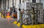U.S. airmen load pallets with baby formula, delivered in trucks from Switzerland, bound for the United States at Ramstein American Air Force base on S