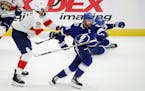 Tampa Bay Lightning center Steven Stamkos works to escape the grasp of Florida Panthers defenseman Aaron Ekblad during the first period of Game 3 on S
