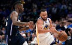 Golden State guard Stephen Curry drives to the basket past Dallas forward Reggie Bullock during the second half of Game 3