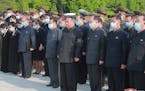In this photo provided by the North Korean government, North Korean leader Kim Jong Un, center, attends a ceremony for Marshal of the Korean People’