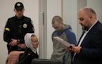 Russian Sergeant Vadim Shishimarin, second from right, listens to a translator during his trial on charges of war crimes for having killed a civilian 