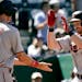Minnesota Twins' Kyle Garlick (30) celebrates with Max Kepler after hitting a two-run home run during the eighth inning of a baseball game against the