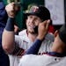 Minnesota Twins' Ryan Jeffers celebrates in the dugout after scoring on a single by Luis Arraez during the third inning of a baseball game Saturday, M