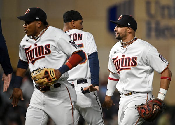 From left, Minnesota Twins second baseman Jorge Polanco (11), designated hitter Byron Buxton (25) and shortstop Royce Lewis (23) celebrate their team�