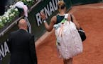 Japan’s Naomi Osaka leaves after losing against Amanda Anisimova of the U.S. during their first round match at the French Open.