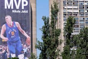 A billboard depicting Denver Nuggets center Nikola Jokic hangs on a building in Belgrade, Serbia.