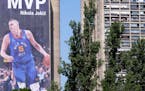 A billboard depicting Denver Nuggets center Nikola Jokic hangs on a building in Belgrade, Serbia.