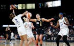 Las Vegas Aces guard Kelsey Plum (10) loses control of the ball as she is guarded by Minnesota Lynx guard Evina Westbrook (2), guard Rachel Banham (15