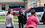 A law enforcement officer helped people cross the street at Uvalde Memorial Hospital after a shooting was reported at Robb Elementary School on Tuesda