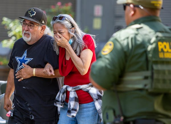 A woman cried Tuesday as she leaves the Uvalde Civic Center, in Uvalde, Texas. At least 14 students and one teacher were killed when a gunman opened f
