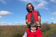 Matt Guidry on a walk with his son, Caleb, 31, in Maple Grove. Caleb has a rare a rare genetic disorder that has affected his speech and cognitive dev