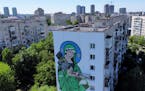 A worker paints a “Saint Javelin”, a Virgin Mary holding an American-made anti-tank missile, in Kyiv, Ukraine, Tuesday, May 24, 2022. No matter wh