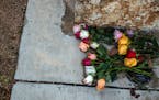 Flowers are left at the base of a monument outside the SSGT Willie de Leon Civic Center in Uvalde, Texas, on Wednesday morning, May 25, 2022. 