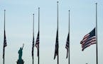 U.S. flags, across New York Bay from the Statue of Liberty, fly at half-staff in Jersey City, New Jersey, on May 25, 2022, as a mark of respect for th