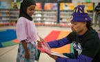 Vikings cornerback Parry Nickerson read with Hodan Mohamed, a kindergartener at Highwood Hills Elementary in St. Paul during a book fair Wednesday.