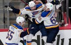 St. Louis Blues center Tyler Bozak, middle, celebrates his overtime goal against the Colorado Avalanche in Game 5 
