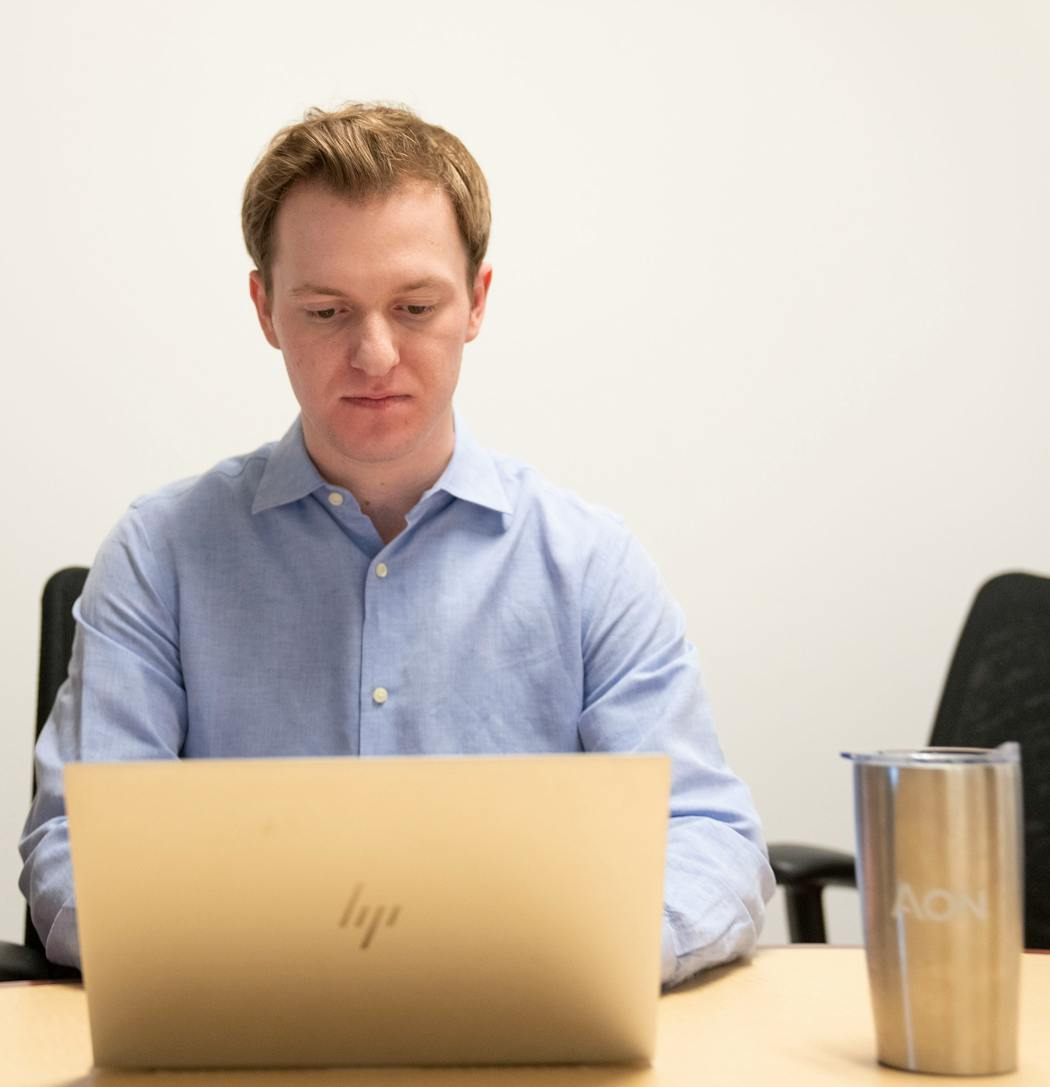 Kai Westby, an Aon apprentice, worked in a conference room at Aon's office in Bloomington. Westby prefers this to his desk due to the extra space, privacy and white board access.