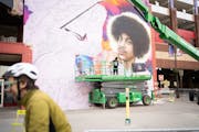 International muralist Hiero Veiga continues work on the Official Prince Mural in Downtown Minneapolis on the Ramp A wall on First Ave. on Tuesday, Ma
