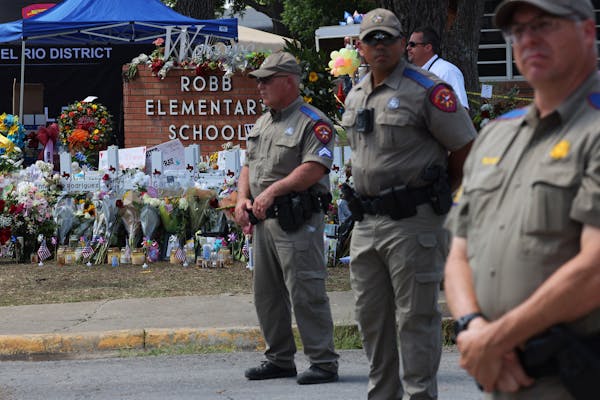 Texas Highway Patrol Troopers stood at attention Friday in front of a memorial for the victims of the mass shooting at Robb Elementary School in Uvald