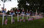 Twenty-one crosses and flags stand next to Main Street as a memorial for the victims killed earlier in the week during an elementary school shooting i