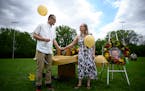Tory Hart and fiancee Josie Josephson hold the urn containing the remains of slain 6-year old Eli Hart before releasing balloons during a celebration 