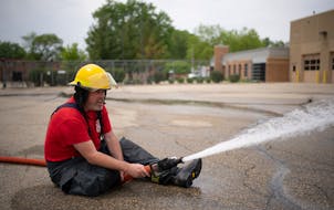 Michael Culhane sprayed water during a training exercise in May 2022 at the St. Anthony Village Public Works facility in St. Anthony, Minn. Culhane wa