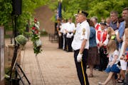 James Schinder, with the Chanhassen American Legion Post 580 honor guard, stood in salute after placing the commemorative wreath during a Memorial Day