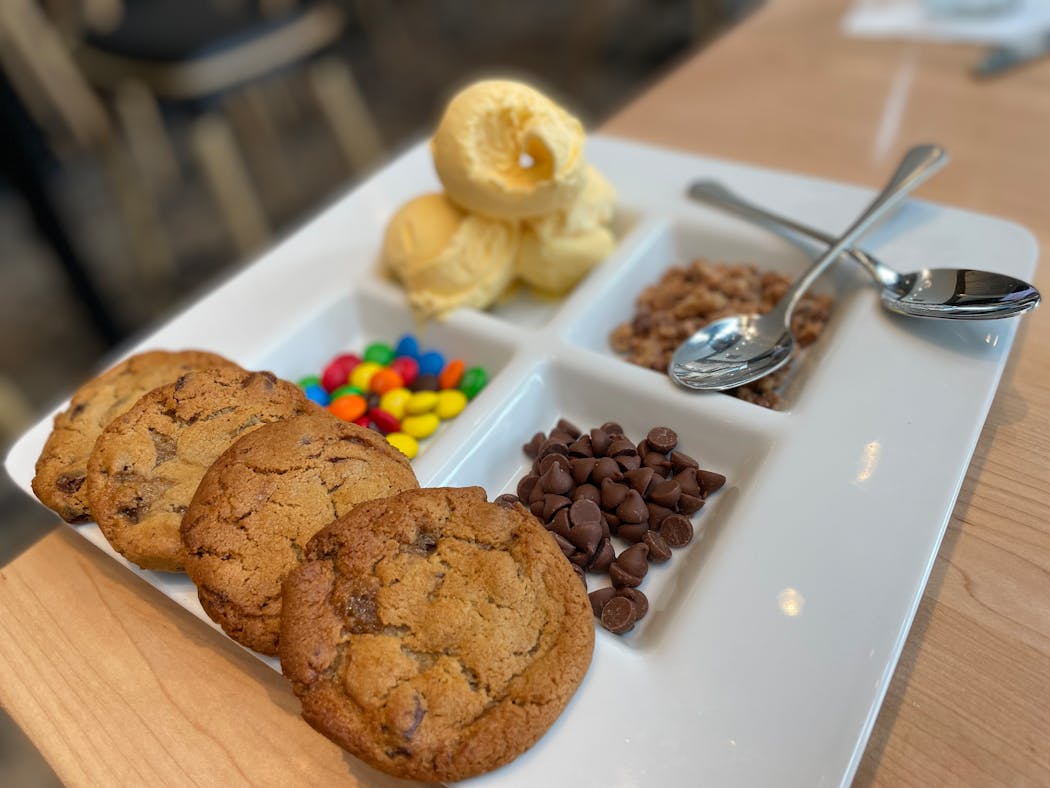 Cookies, warm from the oven, are delivered with a build-your-own ice cream sandwich bar.